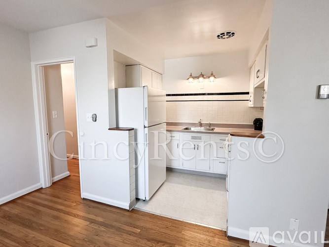 A kitchen with white appliances and cabinets is shown.