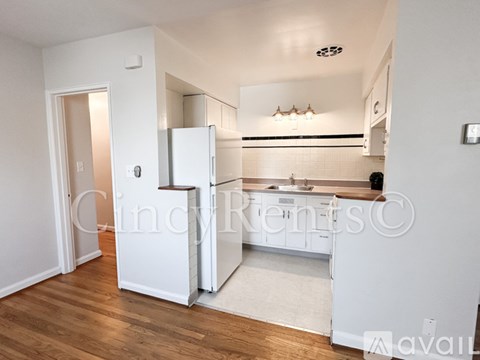 A kitchen with white appliances and cabinets is shown.