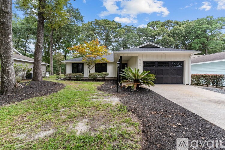 A house with a tree in front of it.