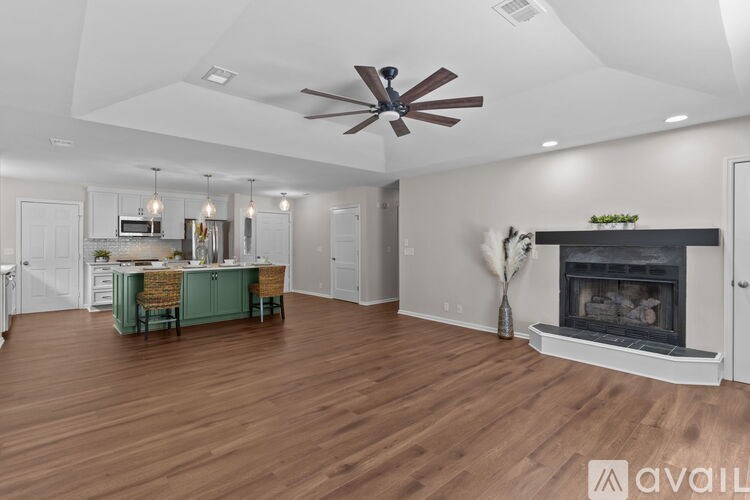 A spacious living room with a fireplace and a dining area.