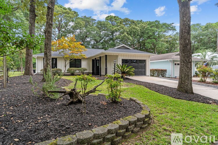 A house with a well-maintained garden in front.