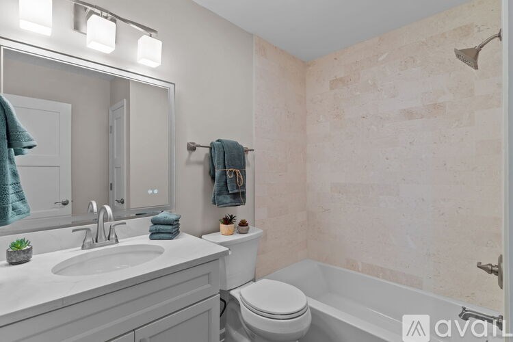 A bathroom with a sink, toilet, and bathtub.