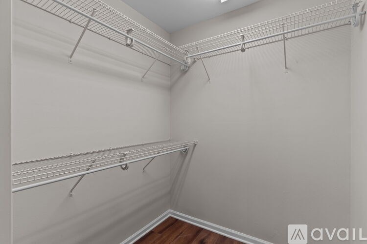 A white wall with a metal rack on it.