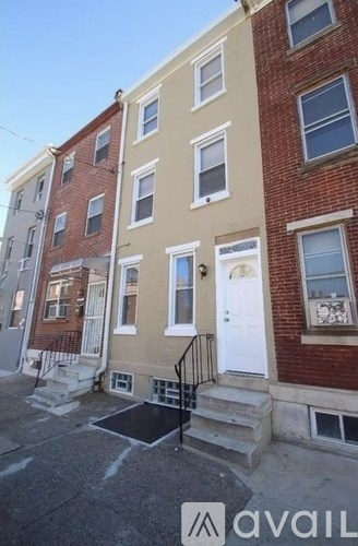 A row of townhouses with a sign that says "avail" on the bottom right.