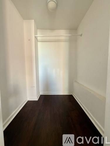 A room with white walls and a wooden floor.