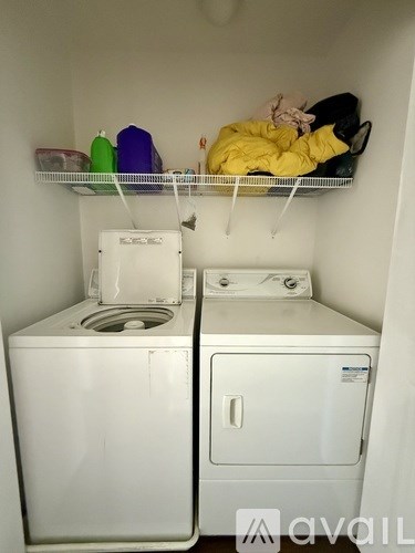 A small laundry room with a washer and dryer.