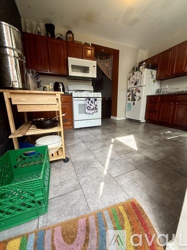 A kitchen with a white fridge and a white oven.