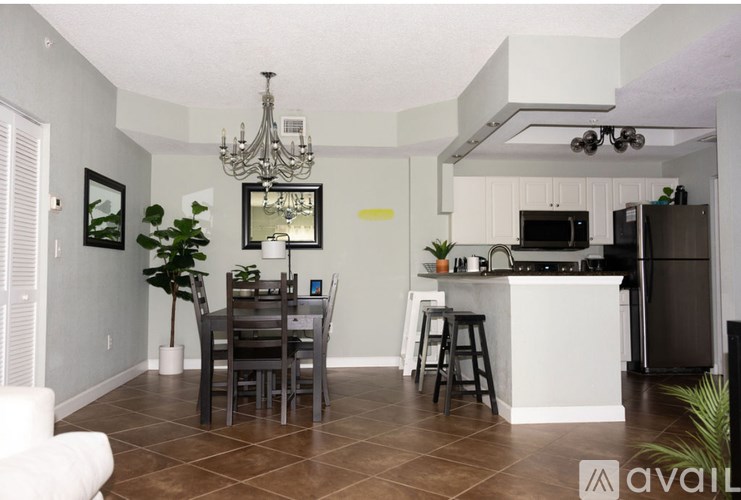 A kitchen with a dining table and chairs.