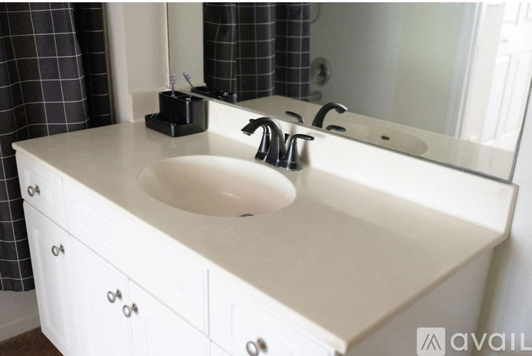 A white bathroom sink with a mirror above it.