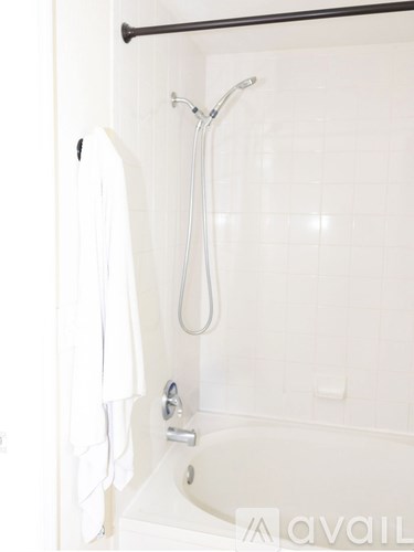 A white bathroom with a tub and a shower.