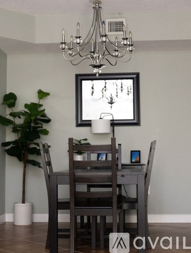 A dining room with a grey table and chairs.