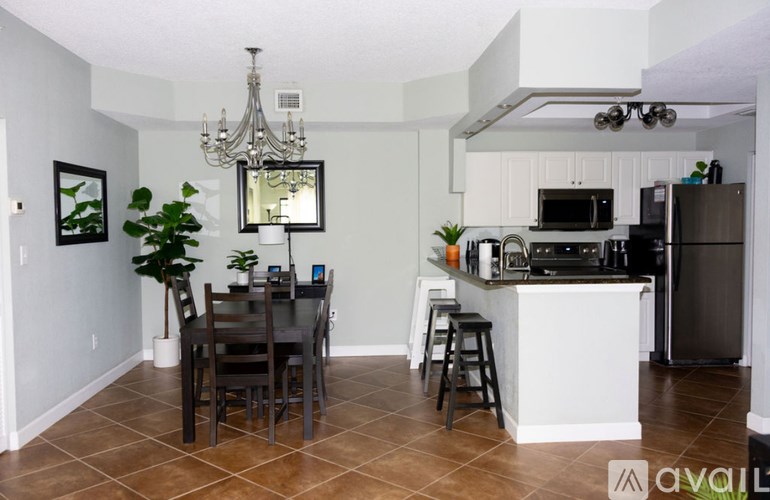 A kitchen with a dining table and chairs.