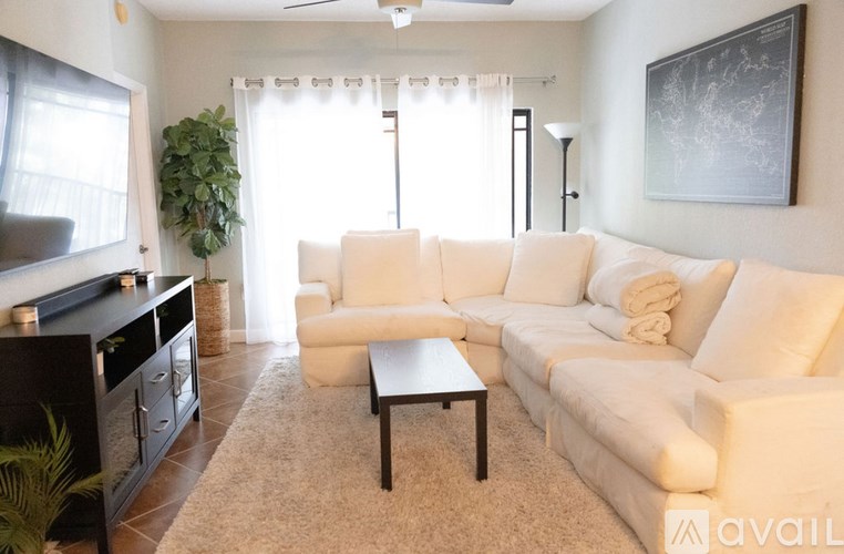 A living room with a white couch and a coffee table.