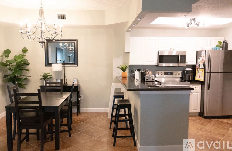 A kitchen with a dining table and chairs.