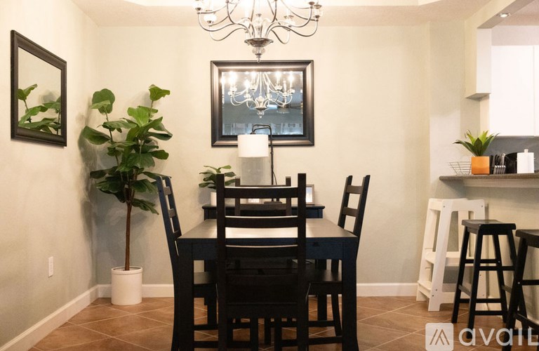 A dining room with a table set for four.