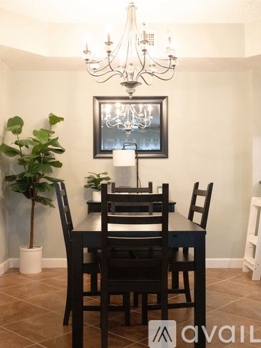 A dining room with a table and chairs.