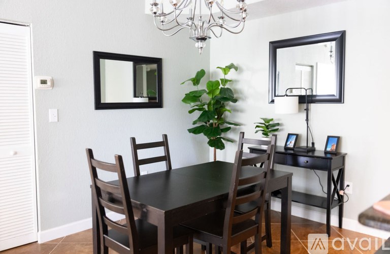 A dining room with a table and chairs.