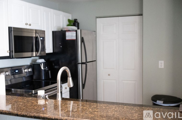 A kitchen with a black fridge and a black stove.