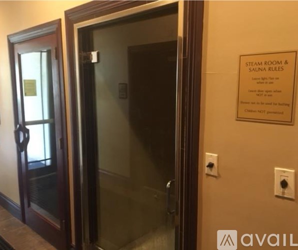 A bedroom with a large bed and a mirror on the wall.