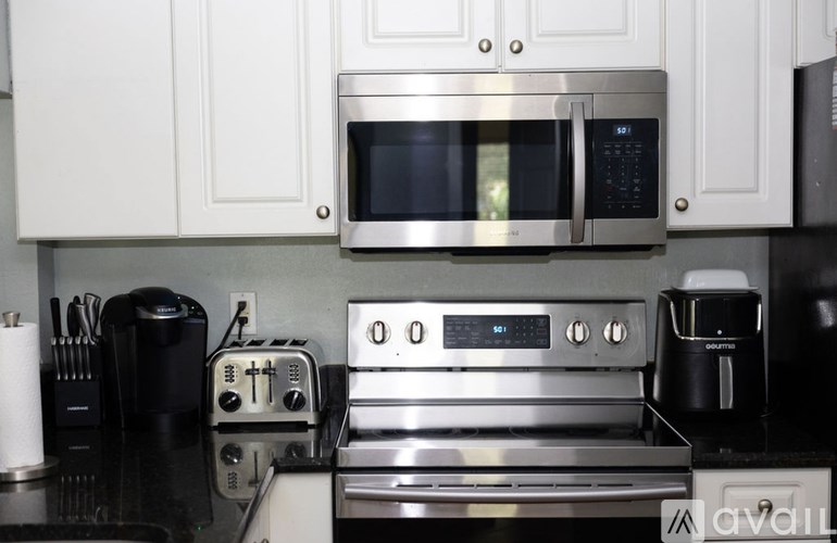 A modern kitchen with a stainless steel oven and microwave.