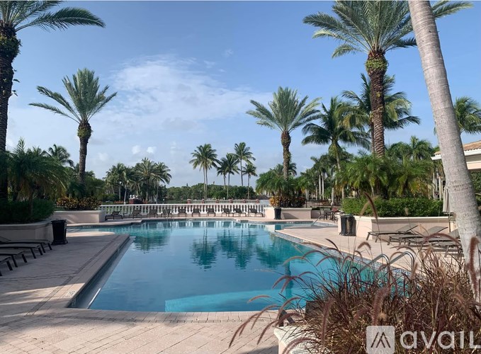 A black dresser with a flat screen TV mounted above it.