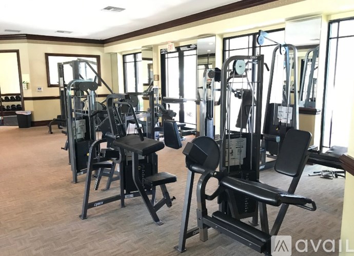 A gym with a variety of equipment including a leg press machine.