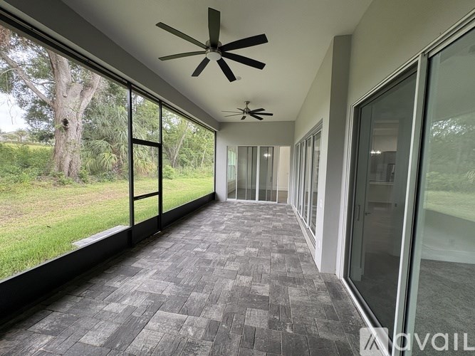 A long hallway with a fan and glass doors.