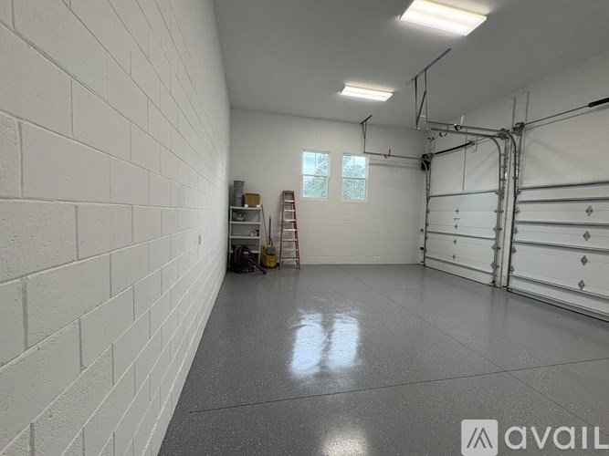 A spacious garage with white walls and a concrete floor.