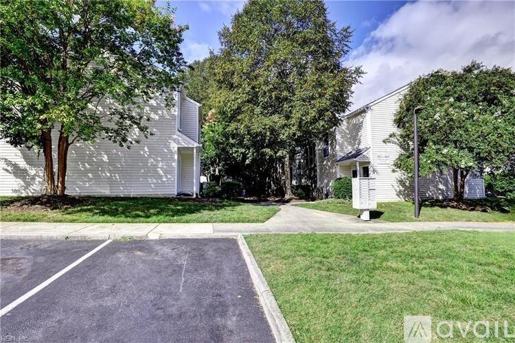 A parking lot in front of a building with a sign that says "available".