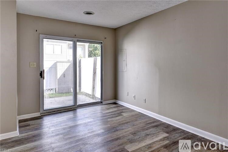 A room with a sliding glass door leading outside.