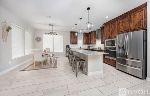 A modern kitchen with wooden cabinets and stainless steel appliances.