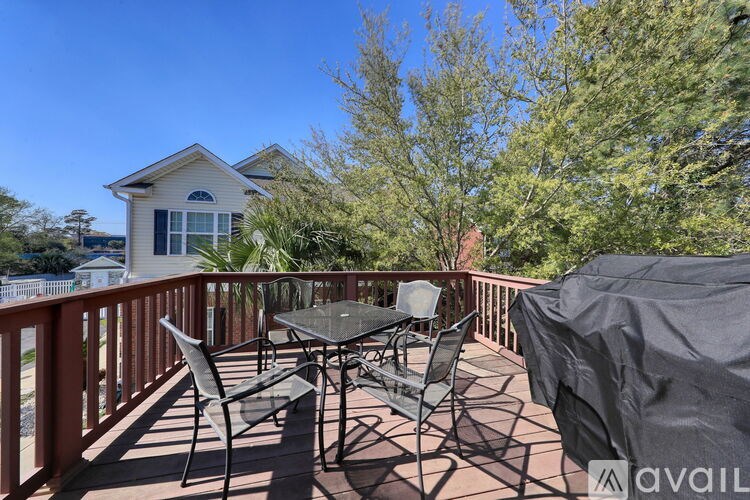 A patio with a table and chairs is covered with a grey tarp.