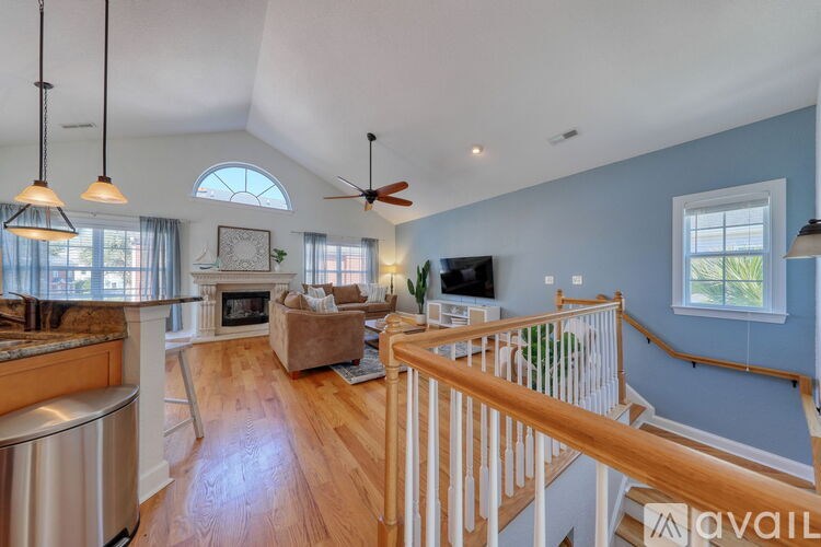 A living room with a fireplace and a television.