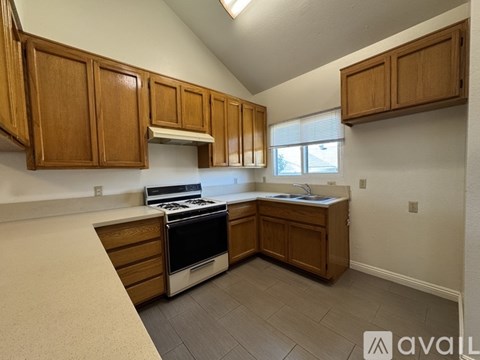A kitchen with wooden cabinets and a black stove top oven.
