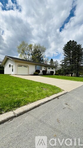 A house with a white garage door is for sale.