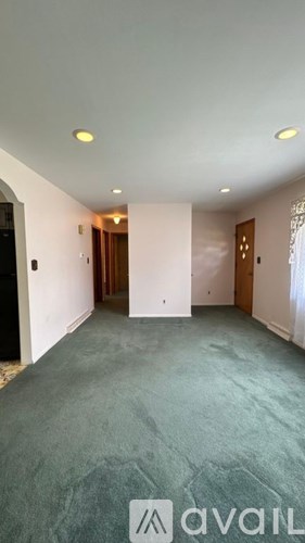 A room with a window and a light on the ceiling.