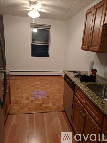 A kitchen with wooden floors and a window.