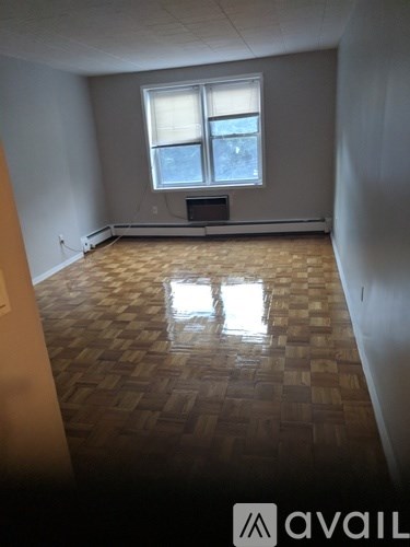 A room with a checkered floor and a window.
