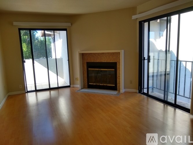 A living room with a fireplace and sliding glass doors.