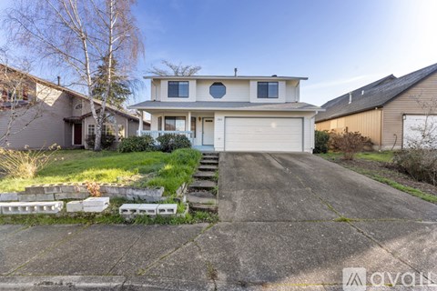A two-story house with a garage and a front porch.