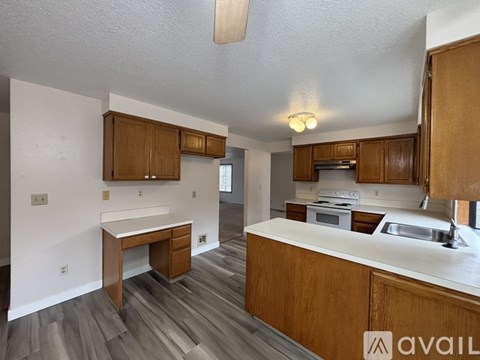 A kitchen with wooden cabinets and a white countertop.