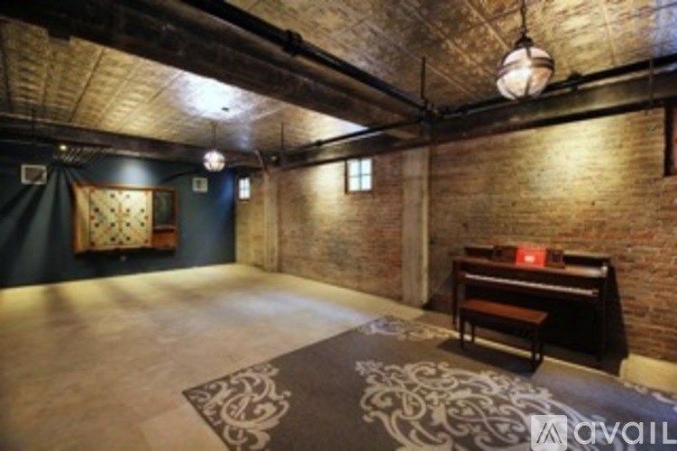 A room with a brick wall and a wooden bench.