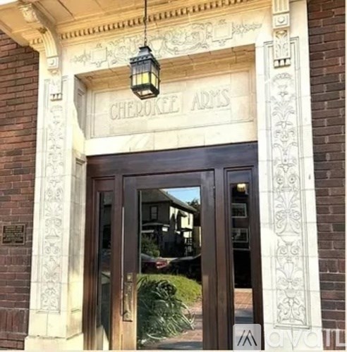 The front door of a building with a sign that reads "Cherokee Arms".
