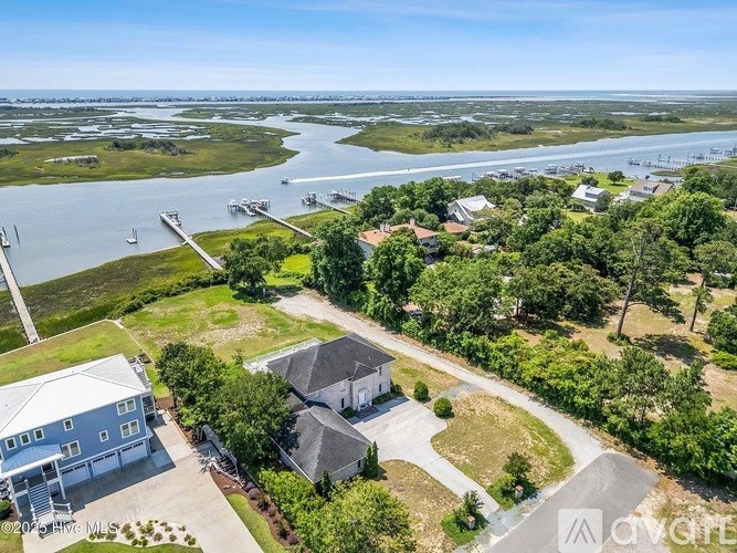A bird's eye view of a residential area with houses and a body of water.