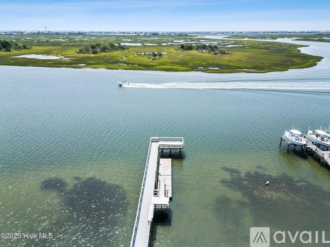 A boat is sailing on the water near a dock.