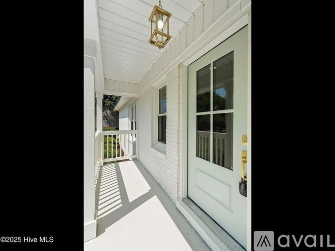 A white door with a glass window and a gold handle is on the right side of the image.