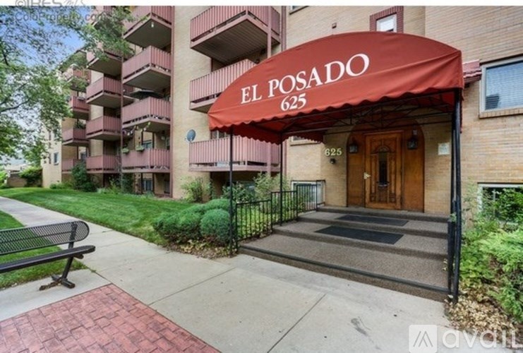 The entrance to El Posado apartments is covered by a red awning.