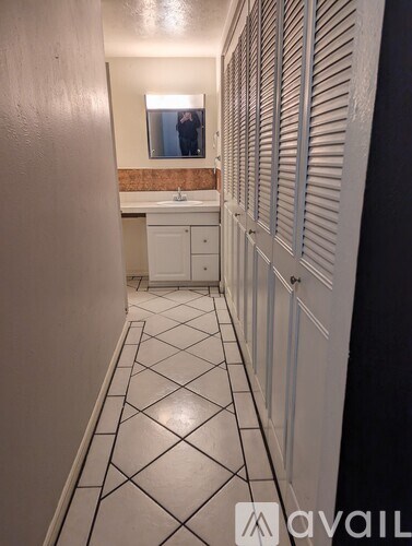 A bathroom with a sink and mirror.