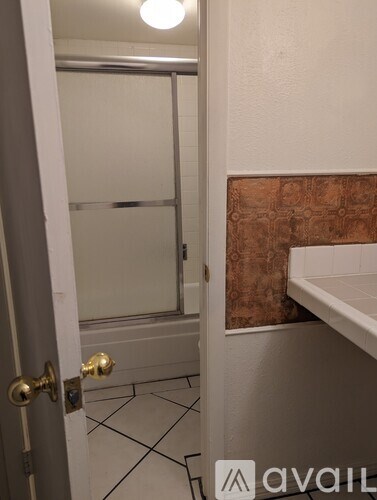 A bathroom with a toilet, sink, and shower.