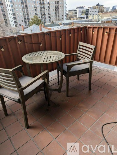A patio with a table and two chairs.